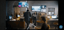 a man holding a newspaper in an office with a cb logo on the bottom right