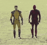 two men in superhero costumes are walking in a field . one is deadpool and the other is wolverine .