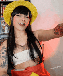 a woman wearing a yellow hat and a red scarf has lordofdumplings on her arm