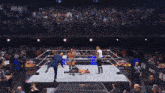 two wrestlers in a ring with a sign that says dynamite