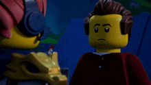 two lego figures are standing next to each other and one is pointing