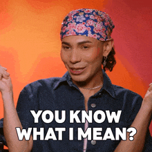 a man wearing a denim jacket and a floral headband says " you know what i mean "