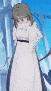 a woman in a white dress is standing in front of a building with a blue sky in the background .