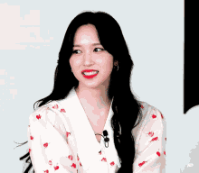 a woman wearing a shirt with cherries on it smiles