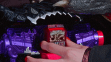a person is playing with a toy that has a red box on it