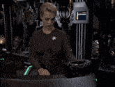a woman stands in front of a computer screen that says ' i ' on it