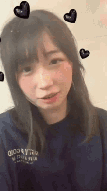 a woman wearing a blue shirt that says good