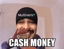 a man wearing a hat that says multivers on it is holding a stack of money