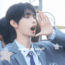 a young man in a suit and tie shouting with the words somos de vicu written below him