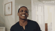 a man is smiling in front of a door with the hashtag #crypttv