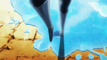 a person 's feet are standing on a cliff overlooking the ocean
