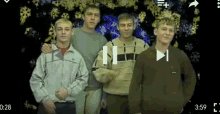 a group of young men standing next to each other with a play button in the middle