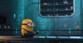 a yellow minion with big eyes is sitting on a table