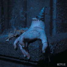 a hand with stitches and a party hat is on a netflix ad