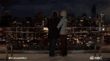 romantic night chicago med cuddling looking over the city cityscape