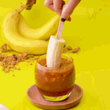 a person is holding a spoon in a glass of food