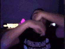a person is making a heart with their hands in front of a sign that says vox .