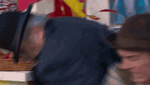 a man in a suit is eating a hot dog