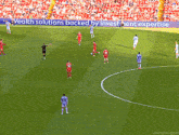 a soccer game is being played in front of a sign that says wealth solutions backed by investment expertise