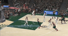 a basketball game is being played in a stadium with nbatickets.com advertisements