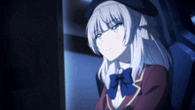 a girl with white hair and a blue bow tie is sitting in a dark room