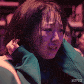 a close up of a woman 's face with the word netflix on the bottom