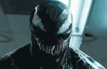 a close up of venom 's face and mouth with sharp teeth