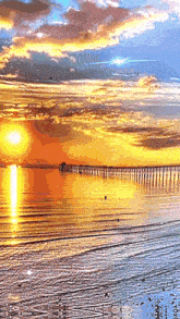 a sunset over a body of water with a bridge in the background