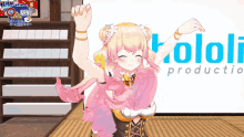 a girl is dancing in front of a sign that says kololi