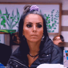 a woman with a purple scrunchie in her hair and a nose ring