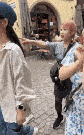 a woman in a floral dress is pointing at something