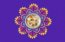 a colorful mandala with a plate of food and candles on it