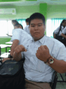 a man wearing a watch and a name tag that says ' a '
