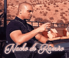 a man is sitting in a chair with a drink in his hand and the words nacho de ramiro written on the bottom