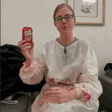 a woman holding a can of dr pepper