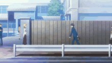 a man in a suit walks across a fence in front of a school