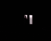a man standing in a room with a sink and a light on