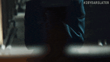 a blurred image of a priest with the words 28 years later on the bottom right