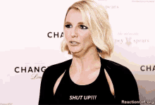 a woman says shut up while standing in front of a chanel sign