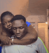 a man in a nike shirt is hugging another man