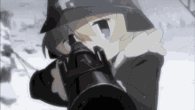a girl wearing a black hat with a cross on it is holding a gun