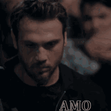 a close up of a man 's face with the word amo on the bottom right