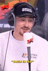 a man wearing headphones and a hat says hello world