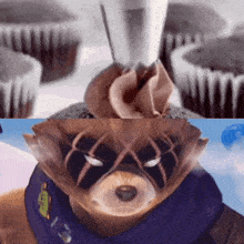 a close up of a cupcake with frosting on it and a teddy bear with a mask on