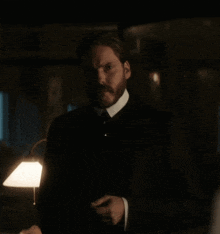 a man with a beard in a dark room