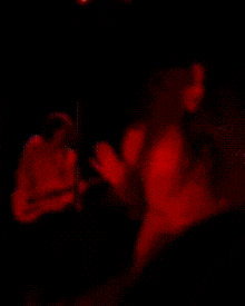 a blurred image of a woman in a red light