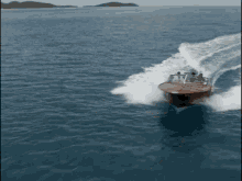 a boat is speeding through the water and making a wave