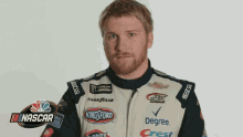 a man with a beard wearing a king ford racing jacket