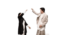 a man and a woman are dancing together in a room .