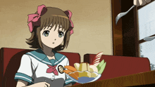 a girl in a school uniform sits at a table with a bowl of fruit